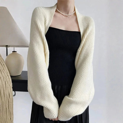 Women's soft ribbed shrug cardigan in neutral tone, open-front draped silhouette with relaxed long sleeves