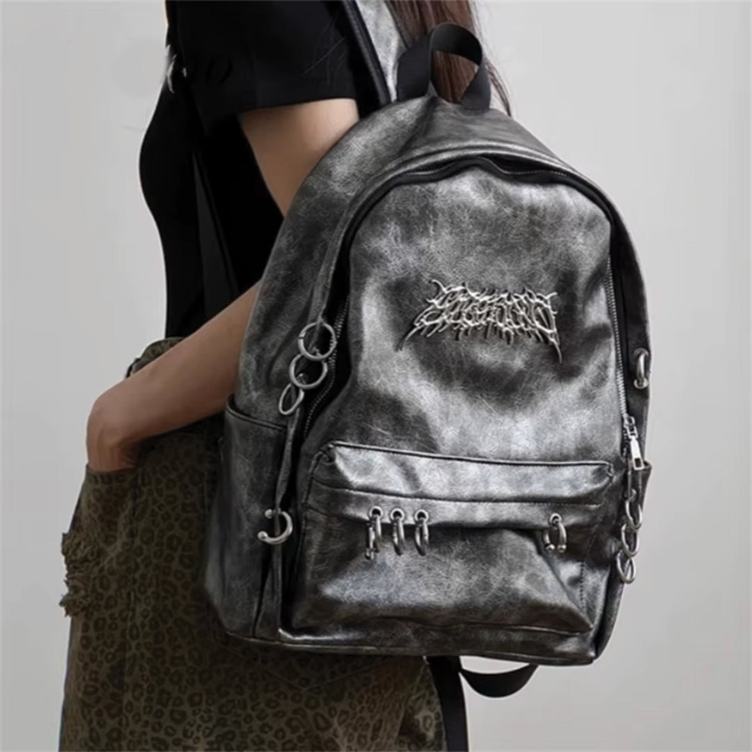 Wavlynn Rebel Chrome vegan leather backpack with metallic circle accents and secure zipper closures for urban style