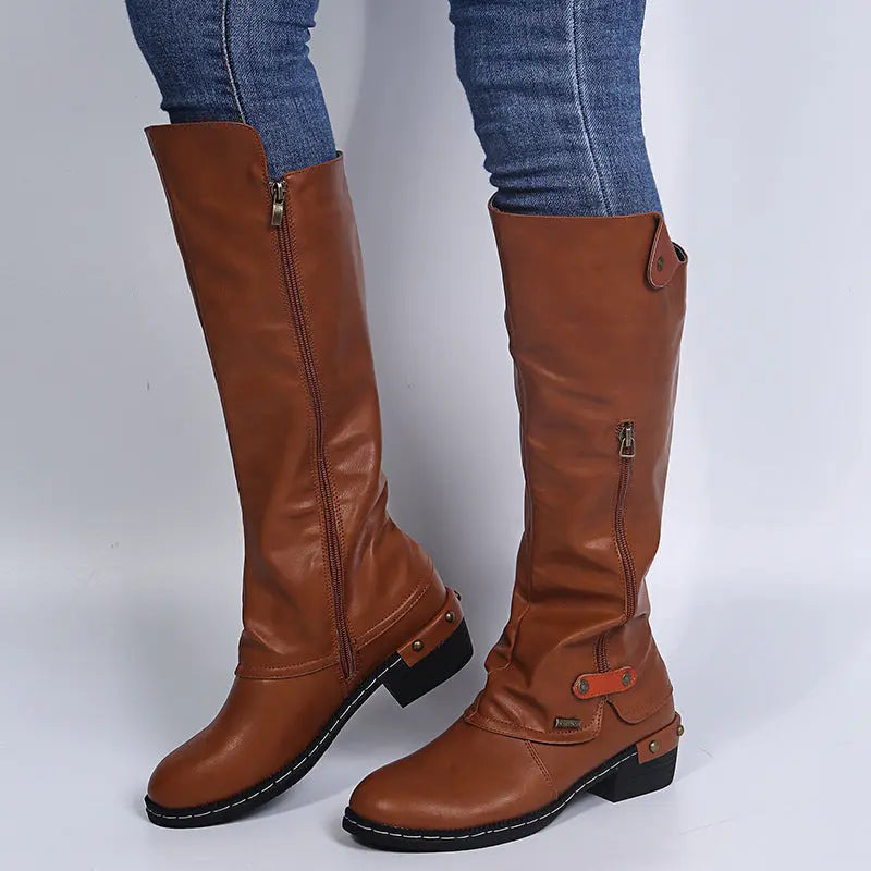 Women's zip-up ankle boots in sleek neutral tone, chic silhouette with side zipper closure