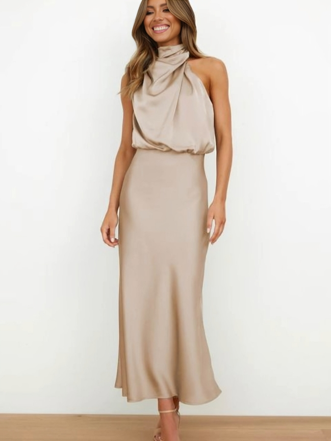 Sleek satin halter evening dress with flowing silhouette in elegant neutral tone
