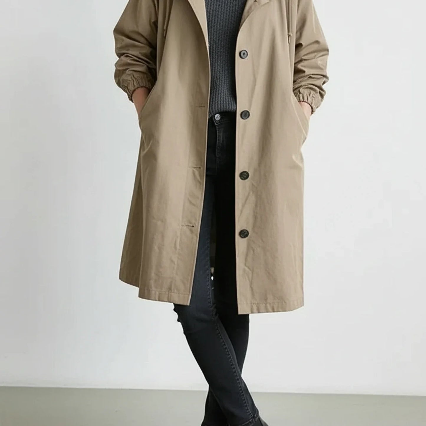 Women's hooded long coat with drawstring hood, A-line silhouette, and side pockets in versatile style