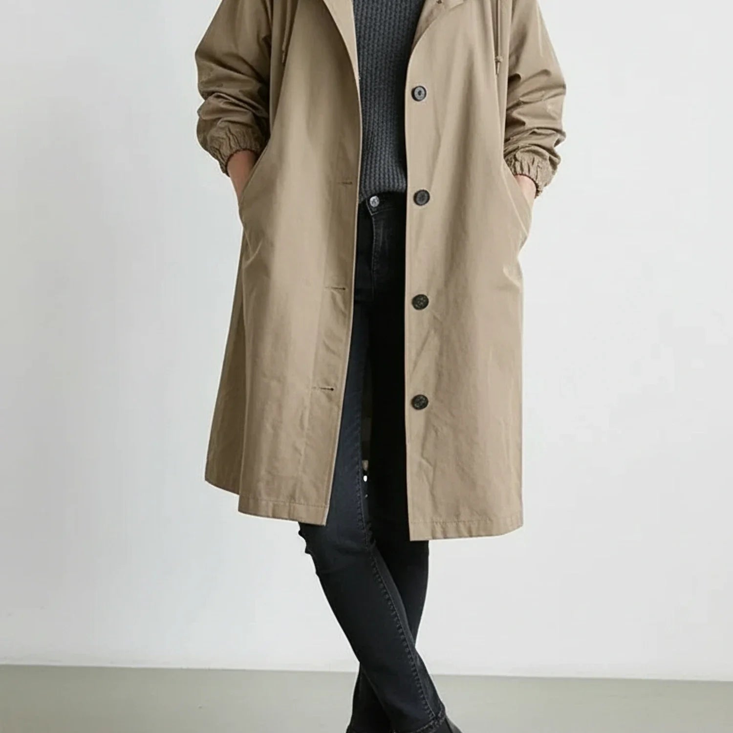 Women's hooded long coat with drawstring hood, A-line silhouette, and side pockets in versatile style