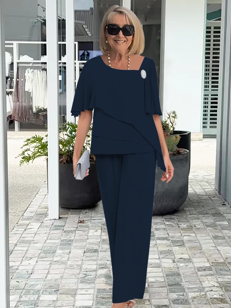 Elegant two-piece feminine set in soft neutral tones, flowing silhouette with refined coordinated design