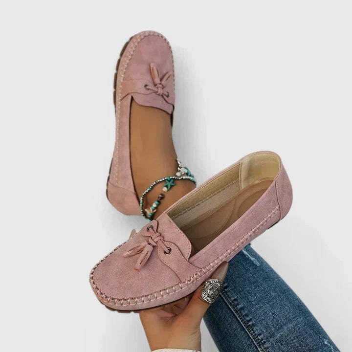 Sage green suede slip-on loafer flats with delicate bow and tassel detail for women