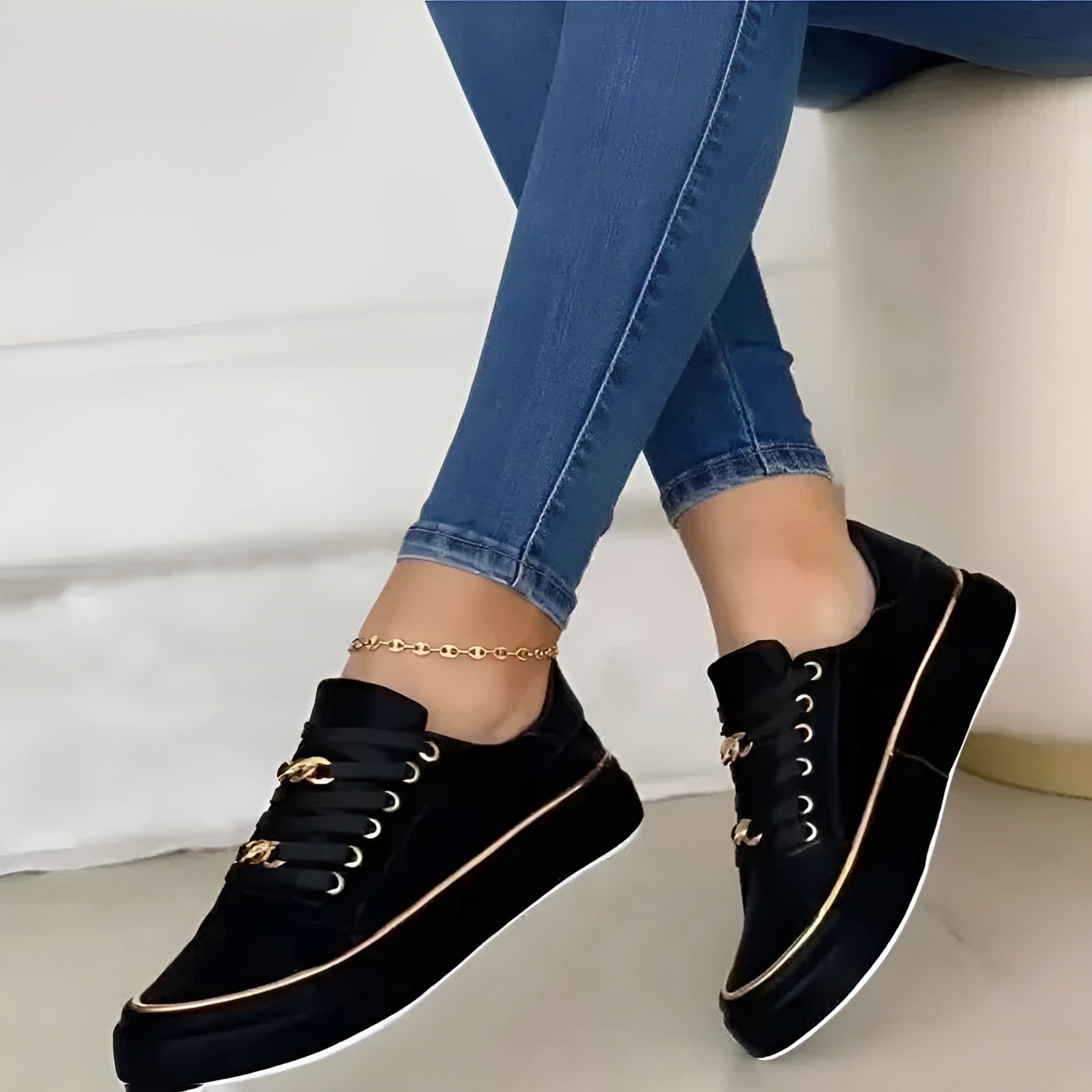 Women's white platform sneakers with gold chain hardware, metallic trim, and lavender ribbon laces