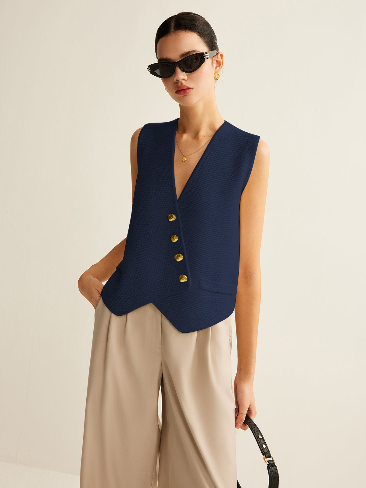 Ivory asymmetrical sweater vest with gold-tone buttons, elegant knit layer in contemporary slim fit