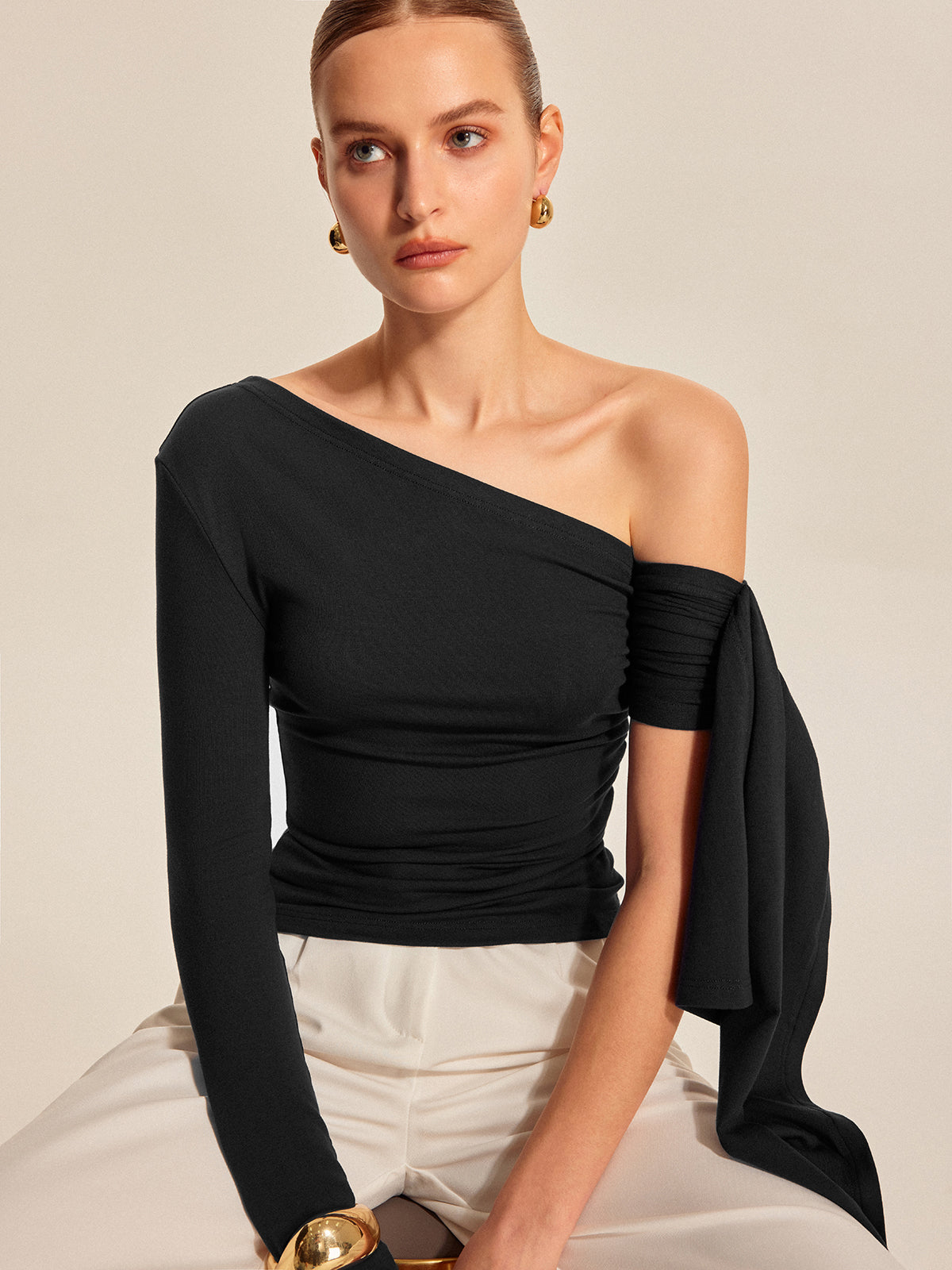 Black asymmetrical cold shoulder draped sleeve top with stretch rayon blend fabric