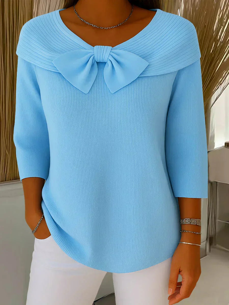Soft feminine sweater with delicate bow accent, breathable knit design for chic effortless style