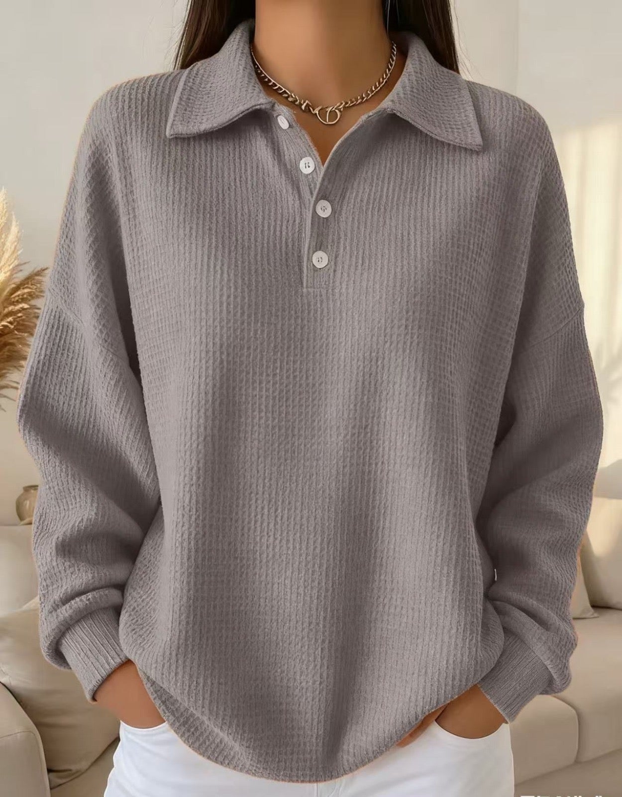 Textured polo sweater in neutral tone with classic knit pattern and refined polo collar