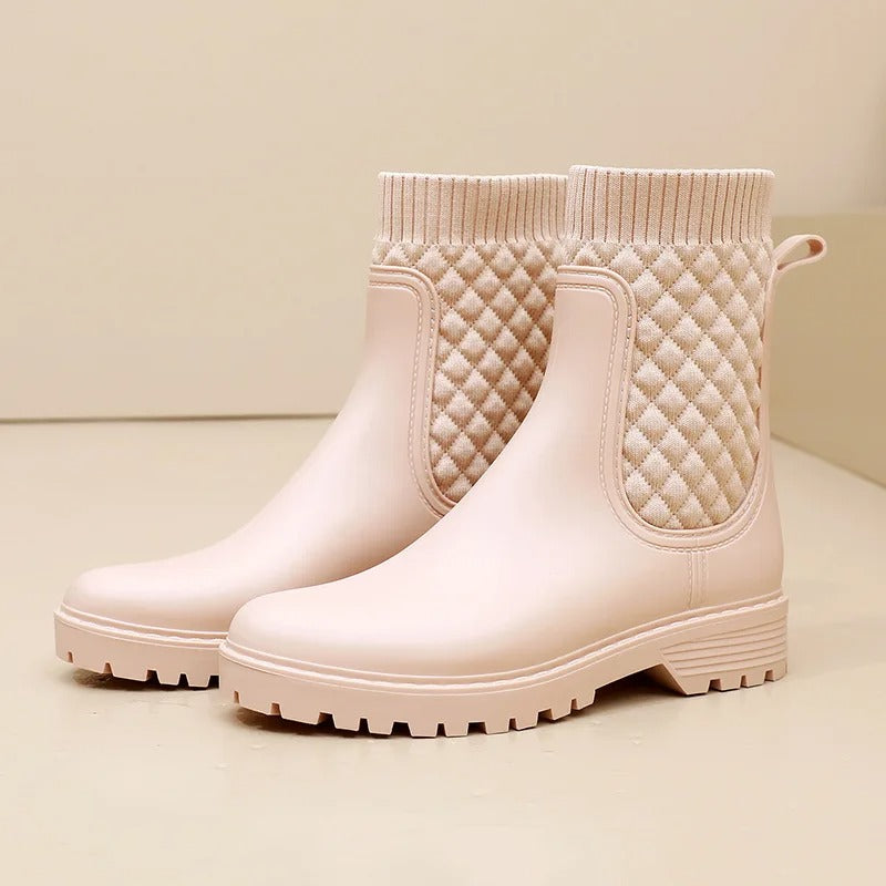 Women's black leather ankle boots with cozy knit-side panel, sleek silhouette for casual elegance