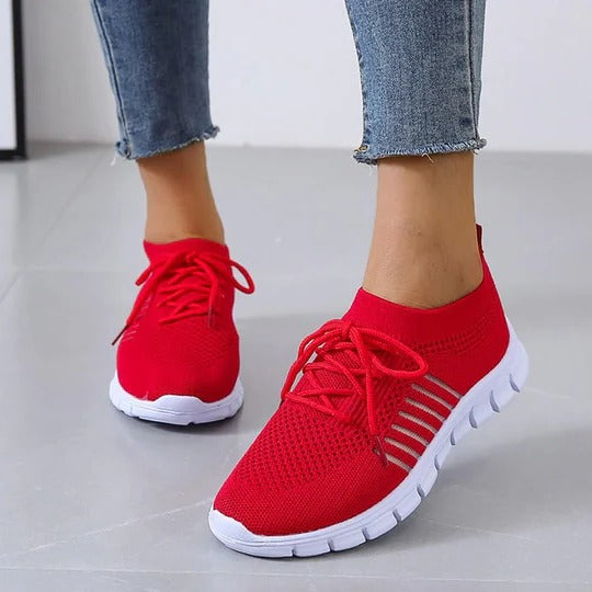 White lightweight athletic sneakers with breathable upper and cushioned insole for everyday wear