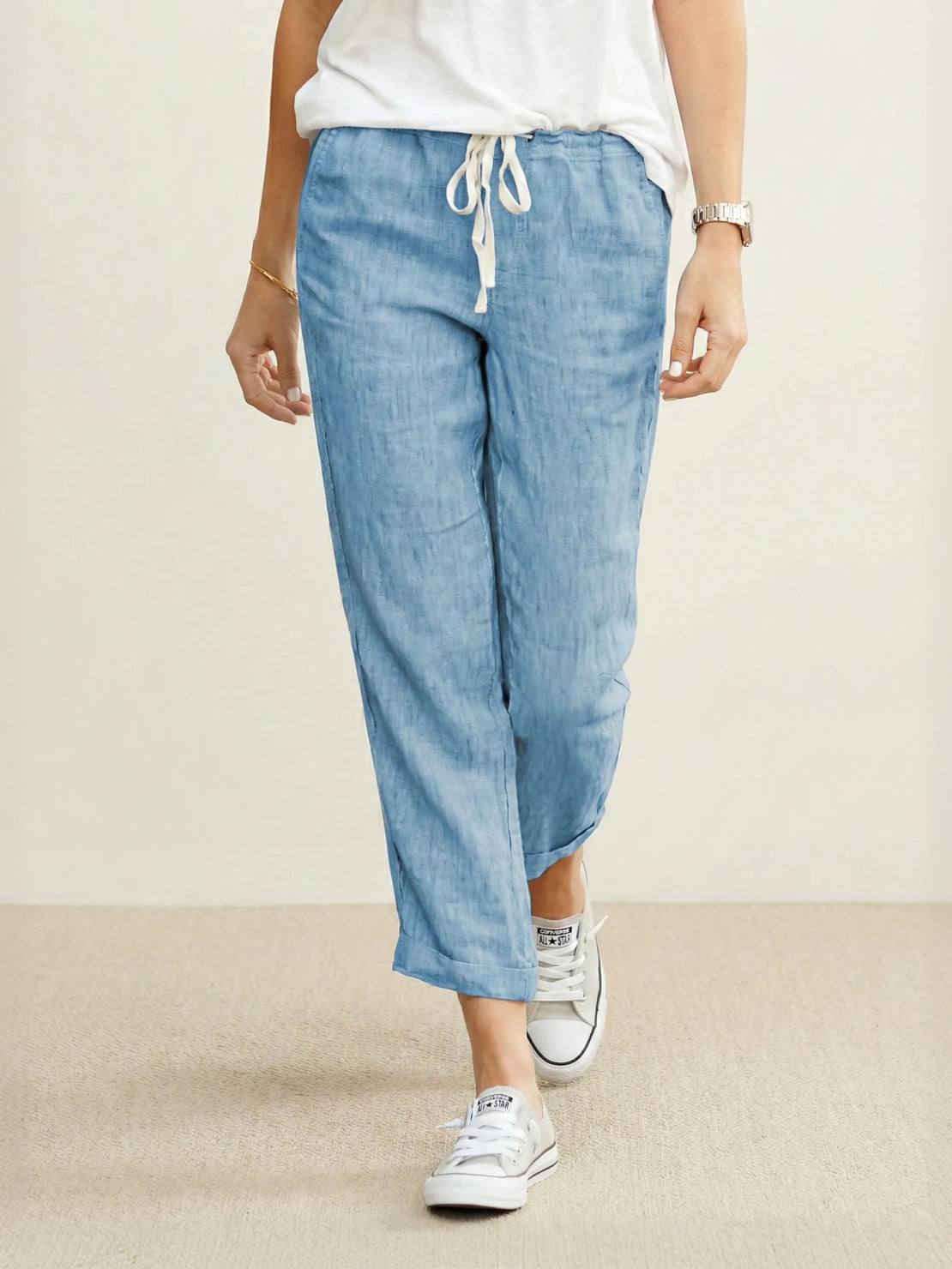 Women's casual straight-leg drawstring pants in neutral tone with relaxed fit and textured fabric