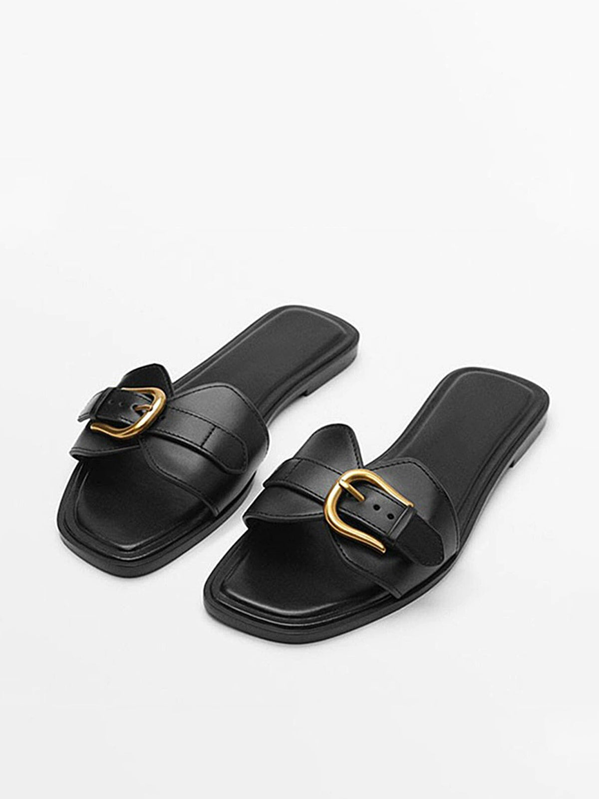 Beige leather slide sandals with double buckled straps and metallic accent for casual summer style