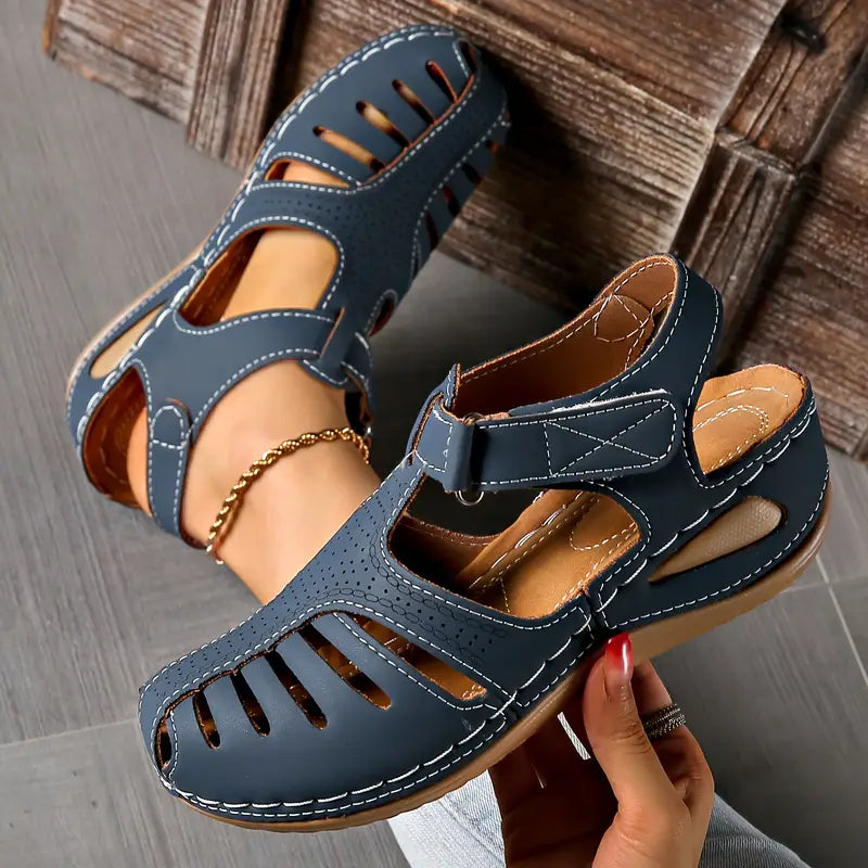 Women's minimalist sandals in neutral tone with cushioned sole and sleek smooth silhouette