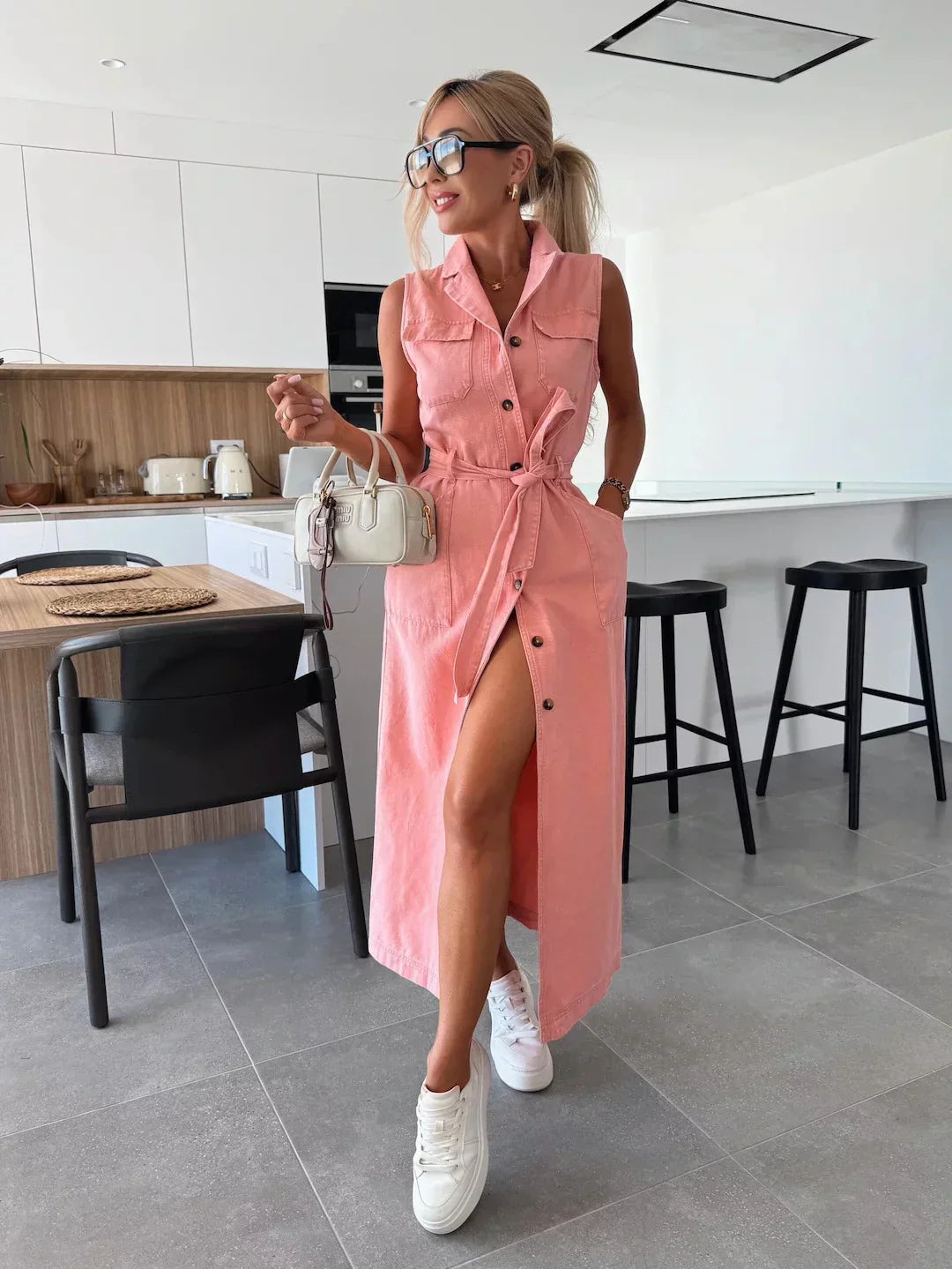Sleeveless blue denim midi shirt dress with adjustable tie belt waist cinch and full-button front
