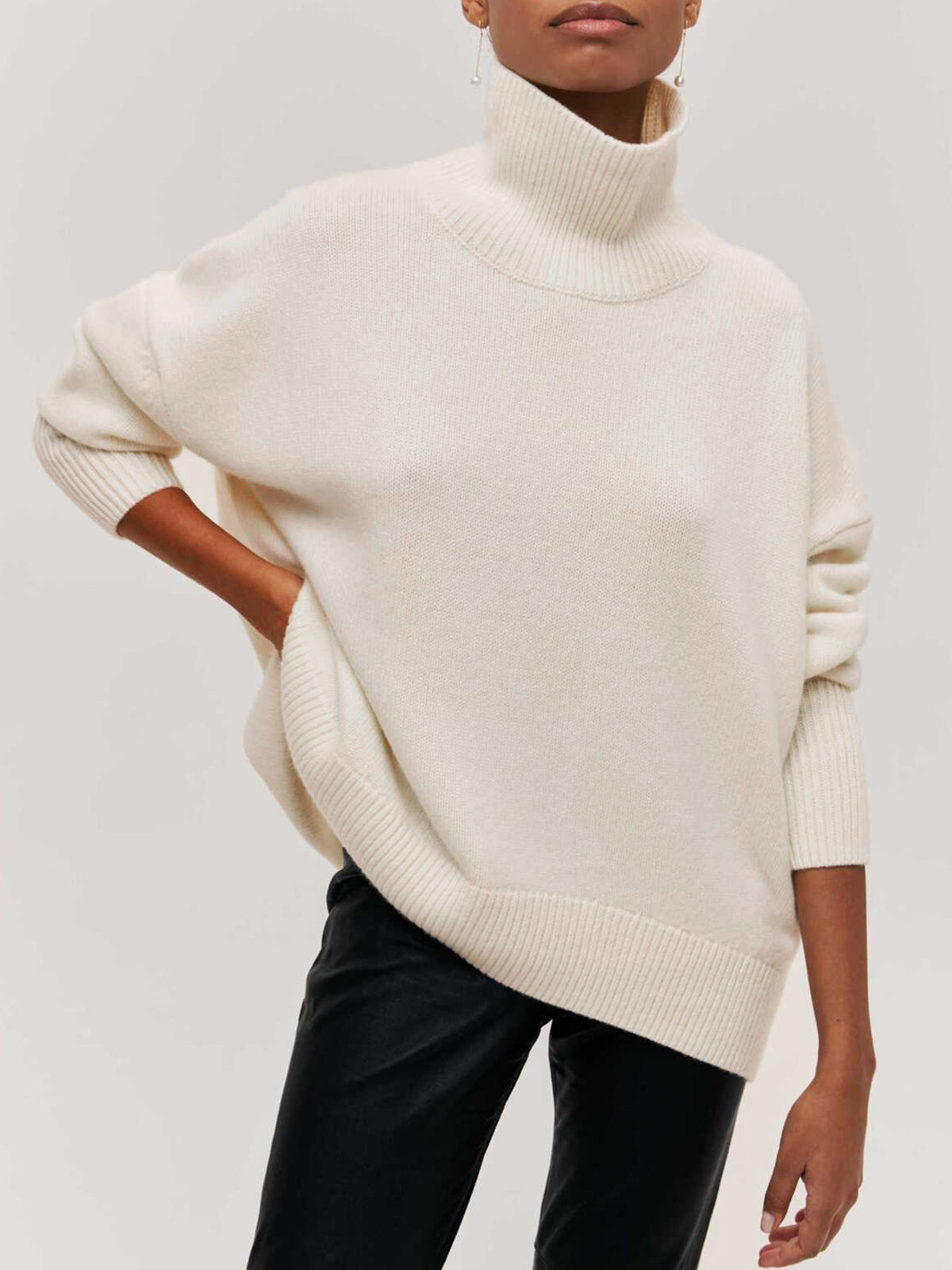 Light blue oversized turtleneck knit sweater with casual shift fit and relaxed silhouette