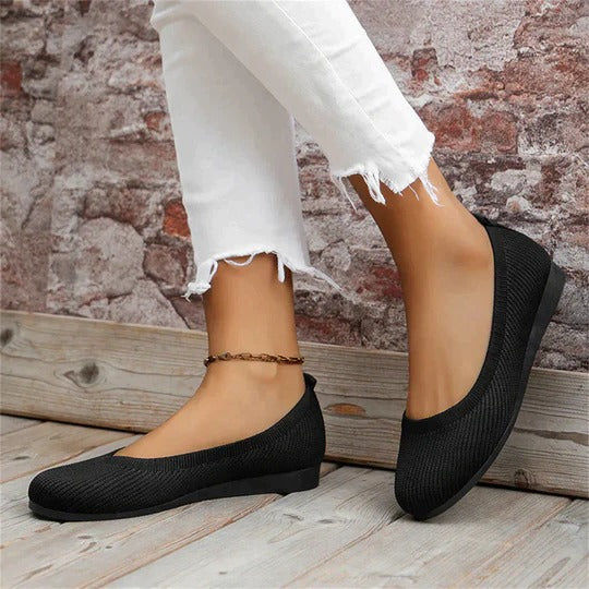 Beige cushioned indoor slippers with contoured footbed, adjustable fit, and textured non-slip sole