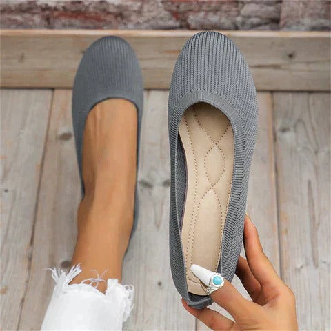 Beige cushioned indoor slippers with contoured footbed, adjustable fit, and textured non-slip sole