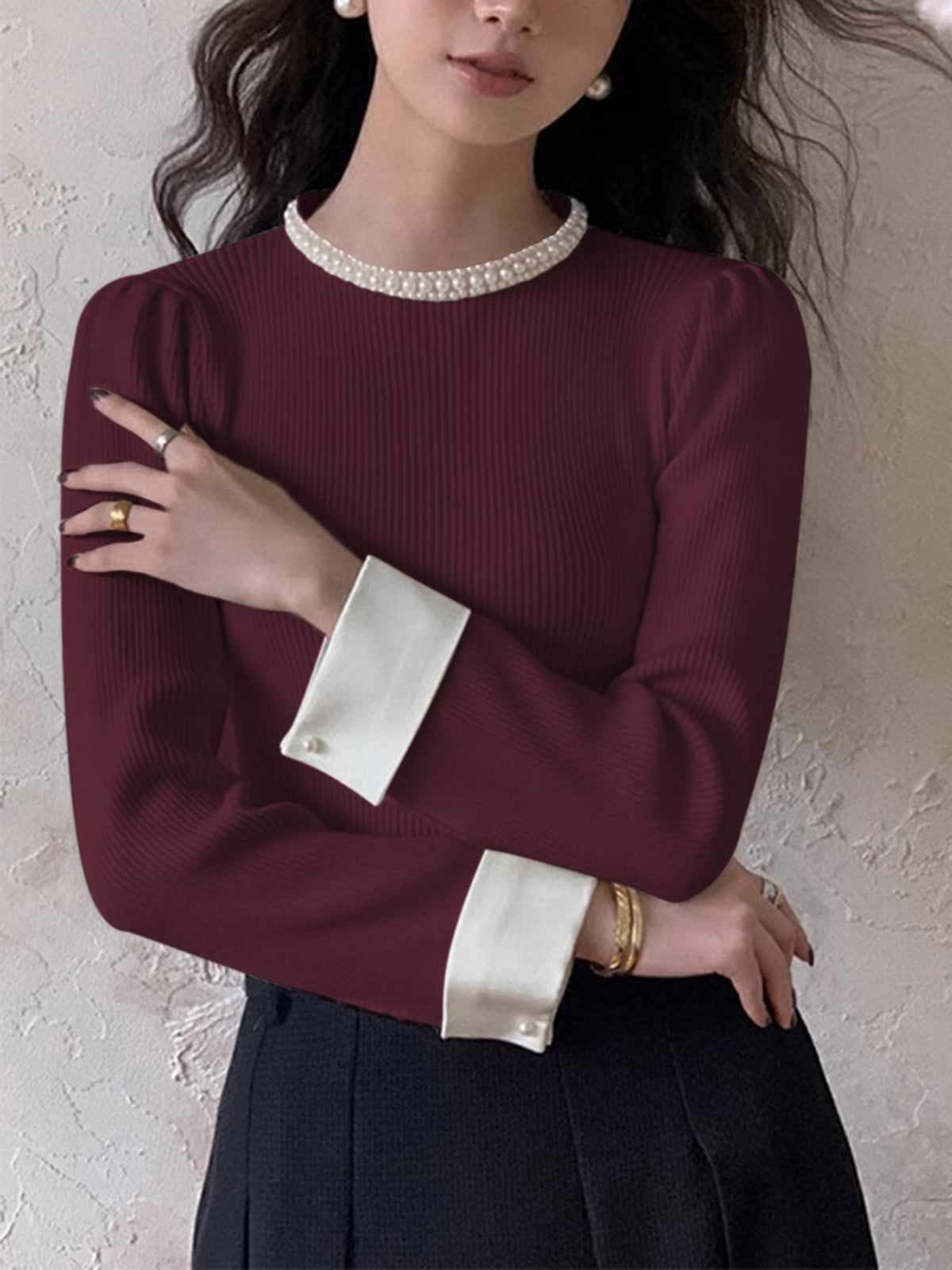 Slim fit elegant knit sweater with contrast trim binding and pearl details, versatile for work or party