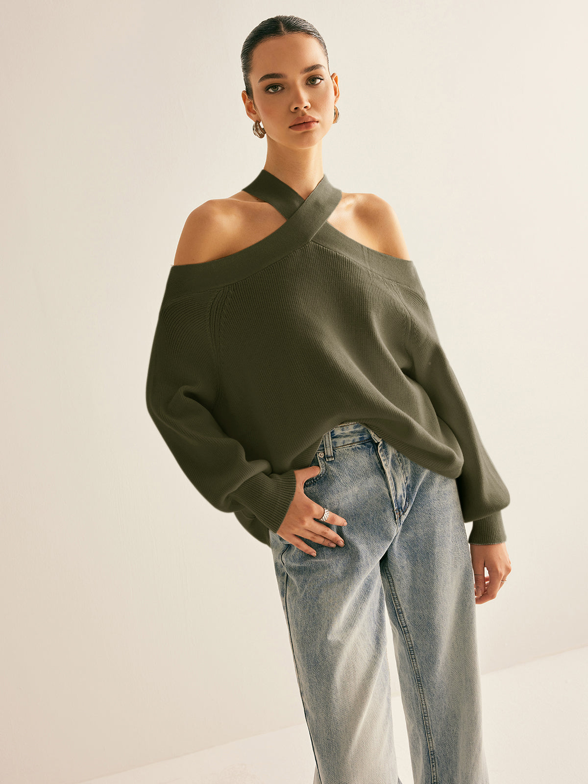 Ivory knit cold-shoulder sweater with crossover collar halter design, casual elegant stretch fit