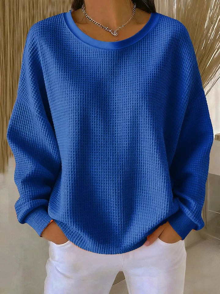 Beige textured knit sweater with cozy relaxed fit and subtle dimensional pattern