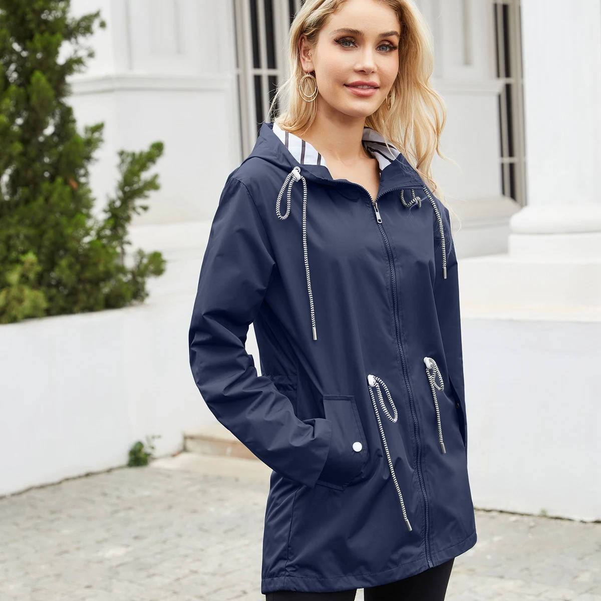 Women's lightweight waterproof rain jacket with attached hood, packable design for daily commute