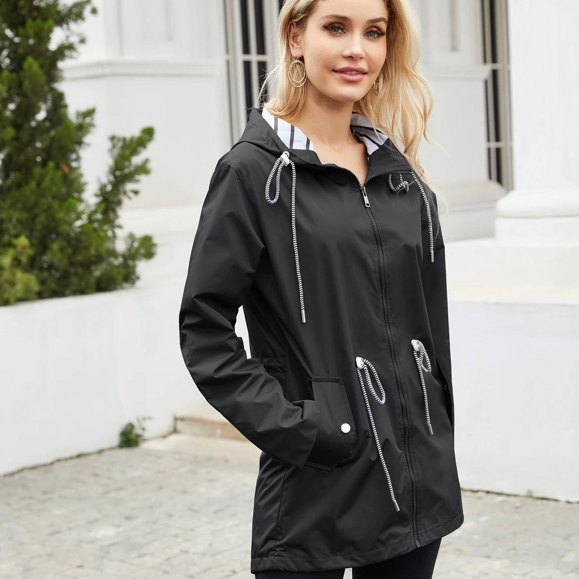 Women's lightweight waterproof rain jacket with hood, packable design for commute and outdoor wear