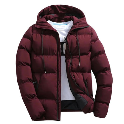 Men's navy quilted puffer jacket with drawstring hood, hip-length fit, and secure zipper pockets