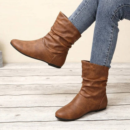 Slouch flat ankle boots in neutral tone, slip-on style with flexible slouchy shaft for effortless wear