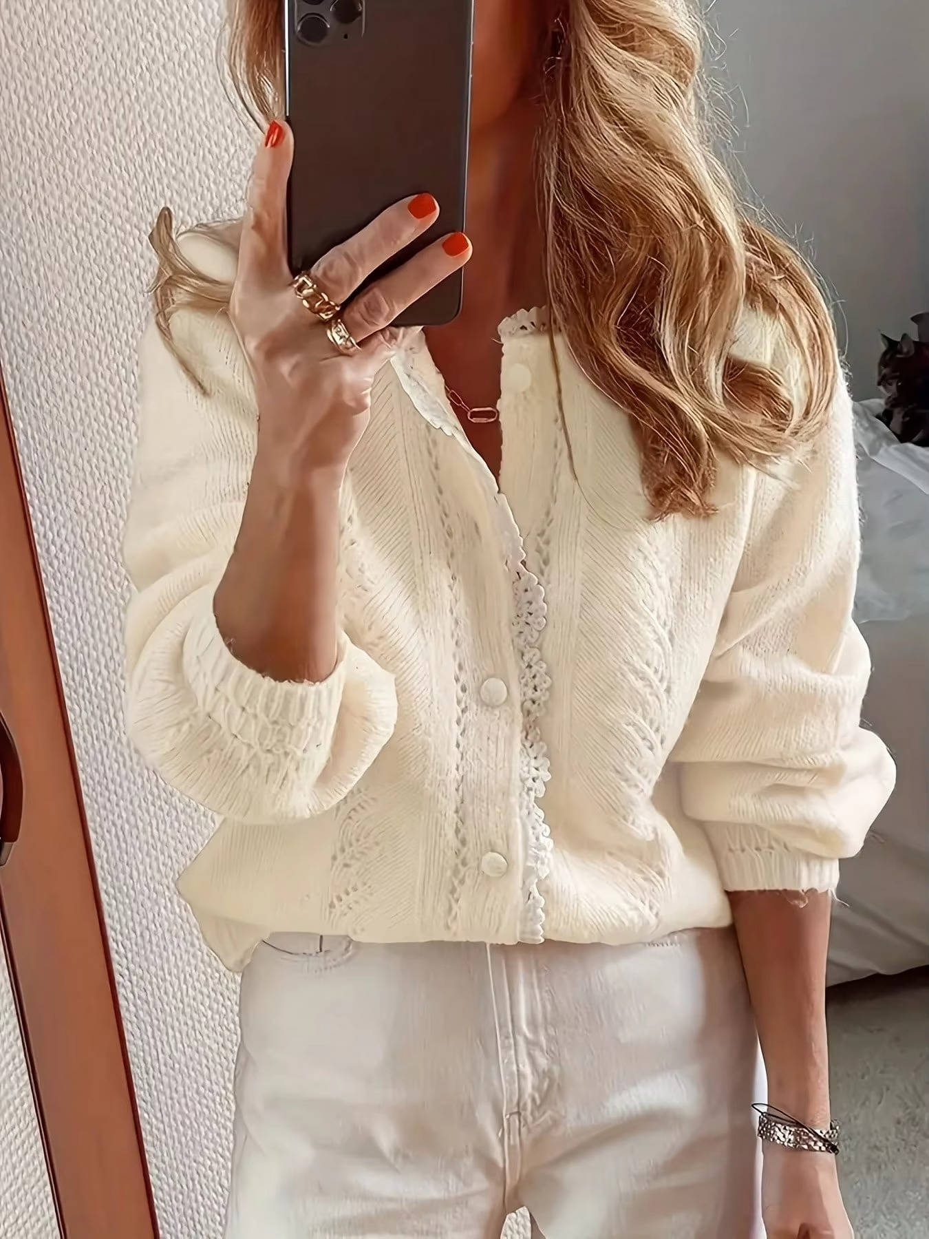 Long sleeved knitted cardigan sweater with delicate lace trim edges for a feminine casual style