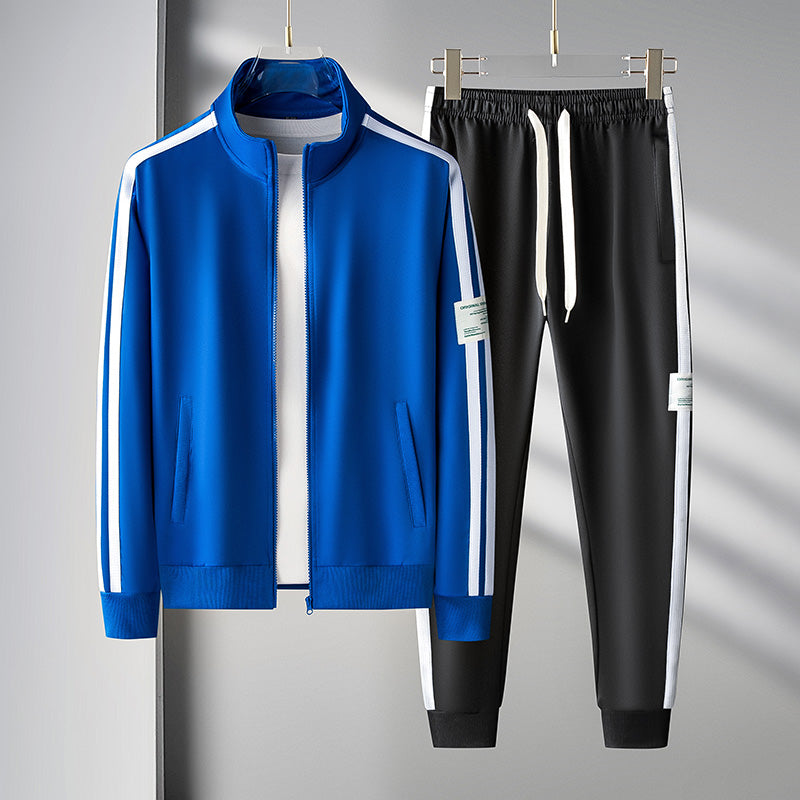 Men's black athletic tracksuit set with green stripe accents, zip front jacket and joggers