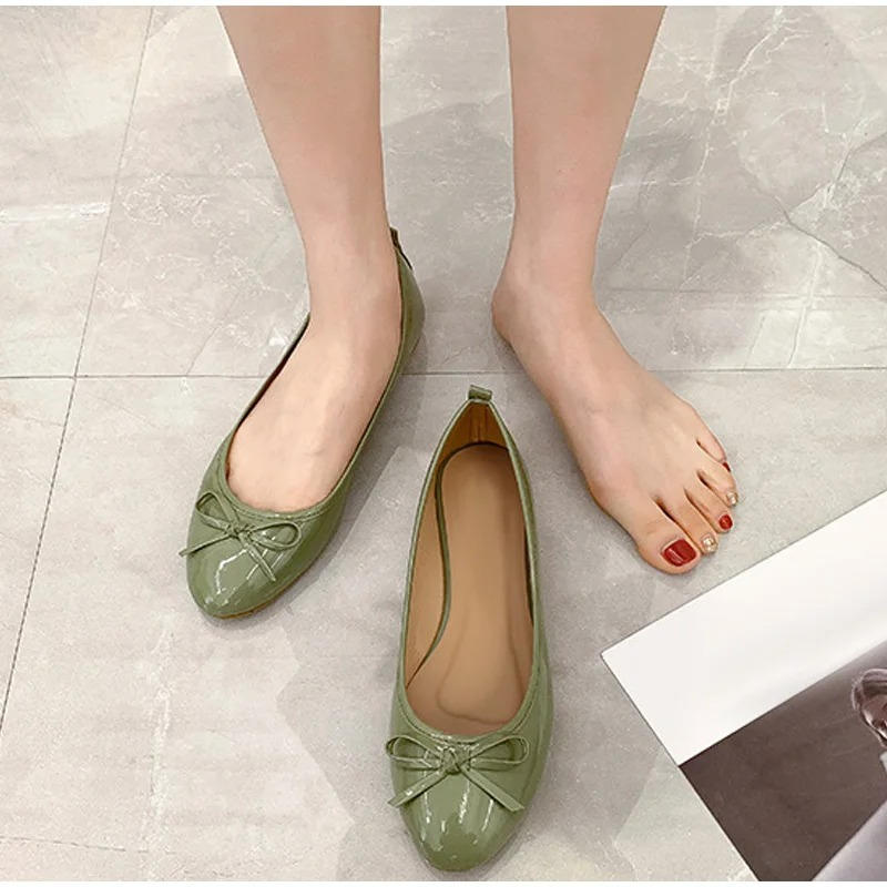 Black leather ballet flats with built-in comfort support, polished round-toe silhouette for all-day wear