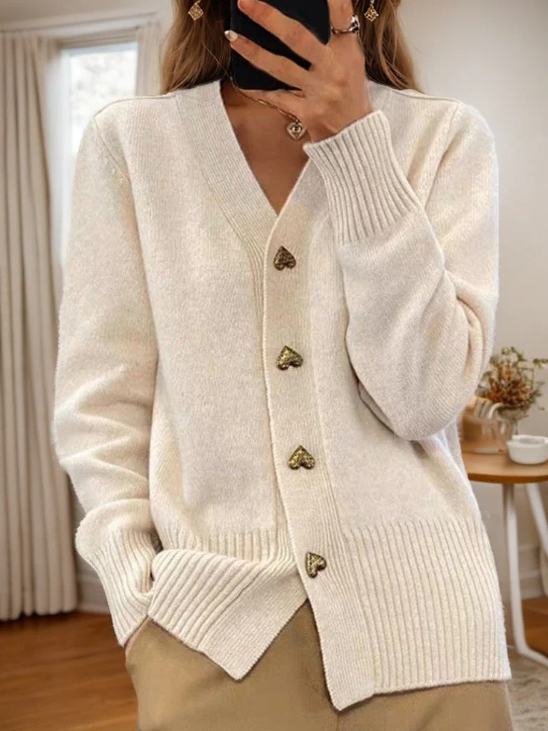 Soft wool-blend V-neck cardigan in cozy knit with playful heart-shaped button details, unisex fit