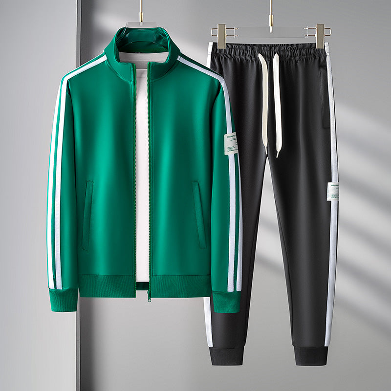 Men's black athletic tracksuit set with green stripe accents, zip front jacket and jogger pants