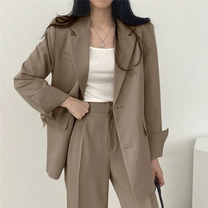 Women's tailored long blazer suit set with high-waisted trousers in classic professional cut