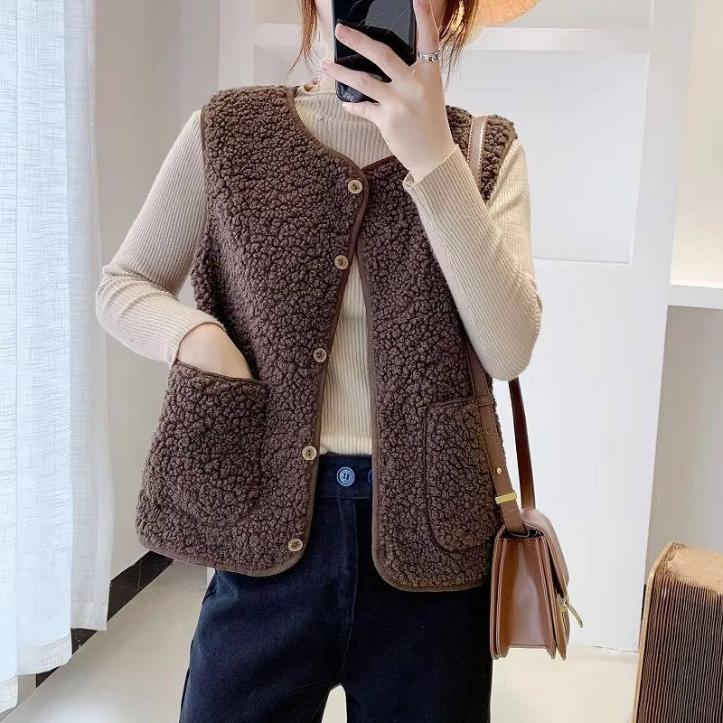 Women's ivory sherpa fleece vest with V-neck, cozy fluffy texture, sleeveless layering piece with pockets