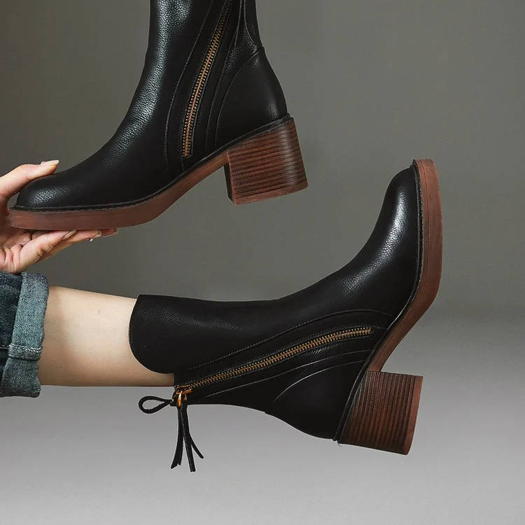 Women's black leather ankle boots with dual side zippers for easy on/off and all-day comfort