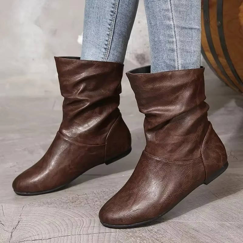 Black slouchy flat ankle boots with slip-on design and flexible shaft for effortless everyday style