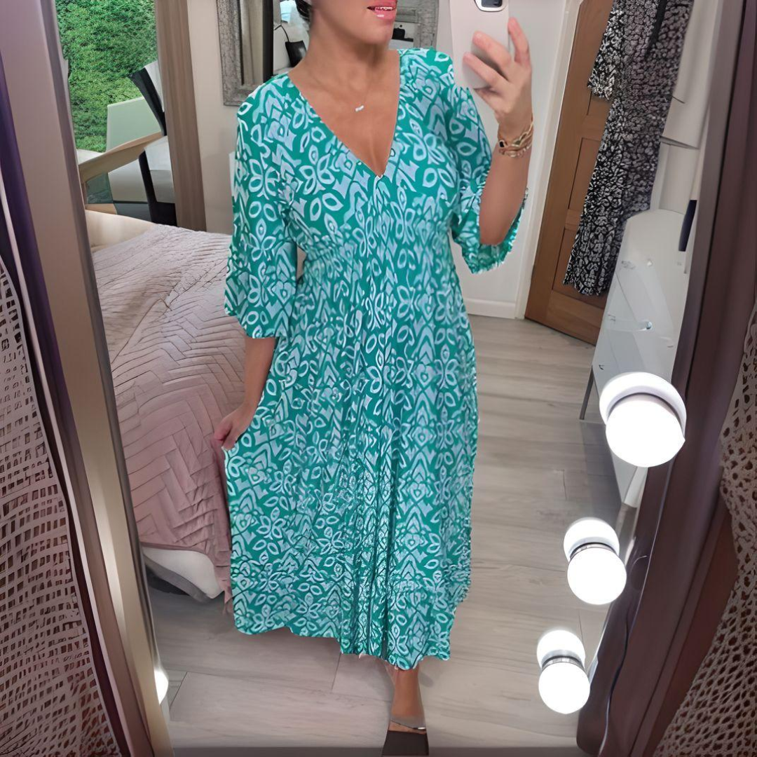 Women's boho flowy printed dress with fitted waist and flowing skirt in artistic pattern