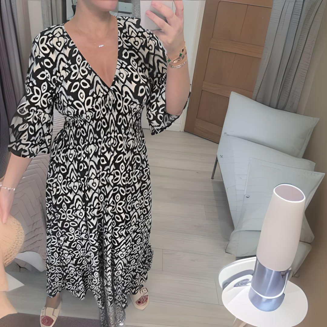 Women's boho flowy printed dress with fitted waist and flowing skirt in artistic print