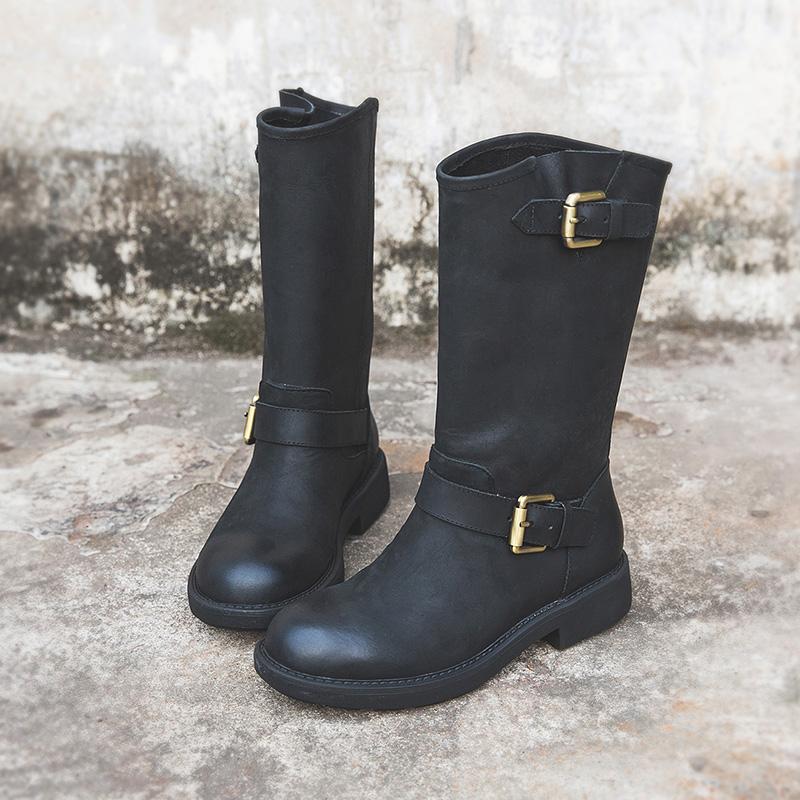Black buckle boots sleek ankle silhouette with bold statement hardware accents for fashion-forward style