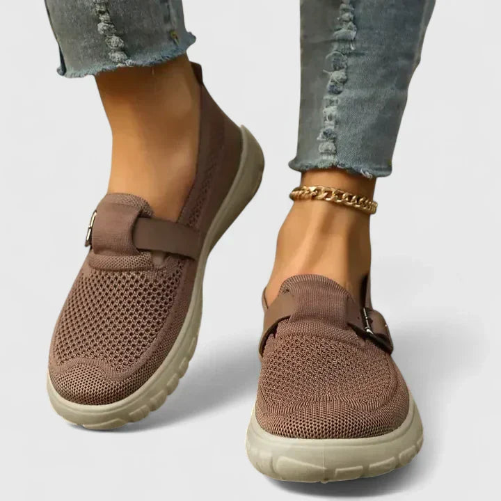 Women's mesh slip-on sneakers in neutral tones with buckle strap detail and perforated breathable upper