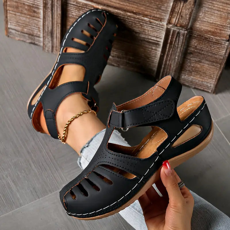 Women's minimalist sandals in neutral tones with cushioned sole and sleek smooth silhouette