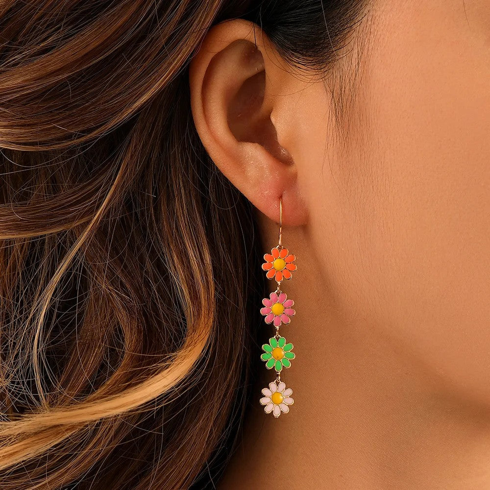 Dainty daisy floral charm drop earrings in gold-toned copper, lightweight tarnish-resistant spring design