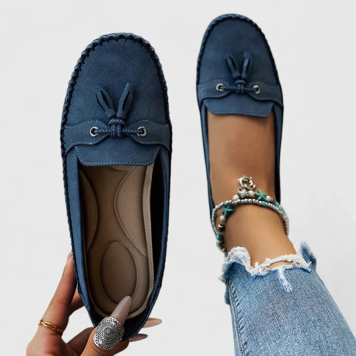 Sage green suede slip-on loafer flats with delicate bow and tassel detail for women