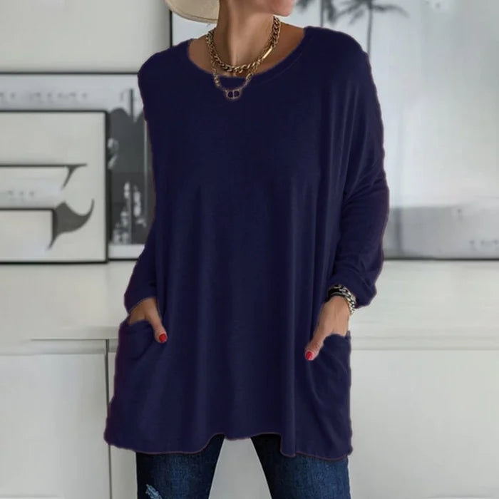 Women's oversized long sleeve tunic top with front pockets, relaxed knit fit and flared hem