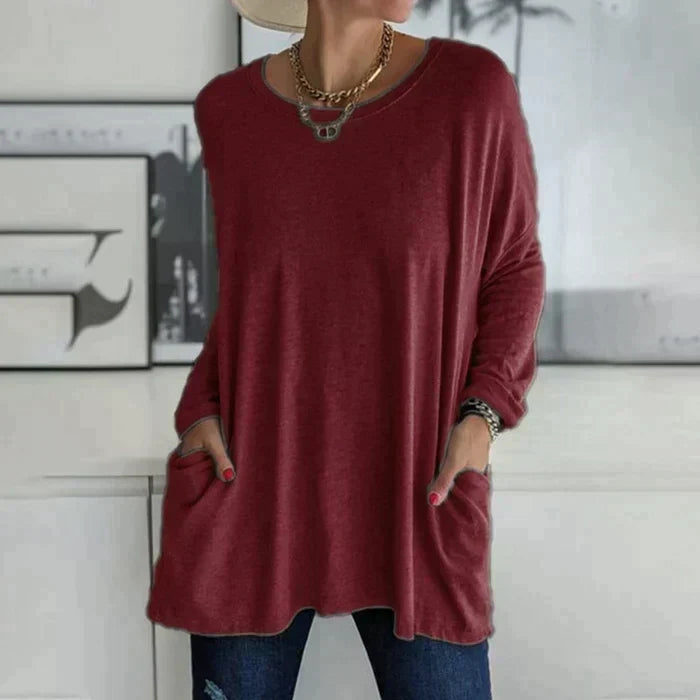 Women's ruby red oversized long sleeve tunic top with front pockets and flared hem