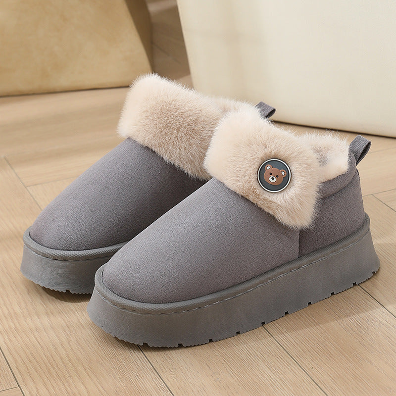Beige ankle slipper boots with faux fur trim, button detail, and plush fleece interior