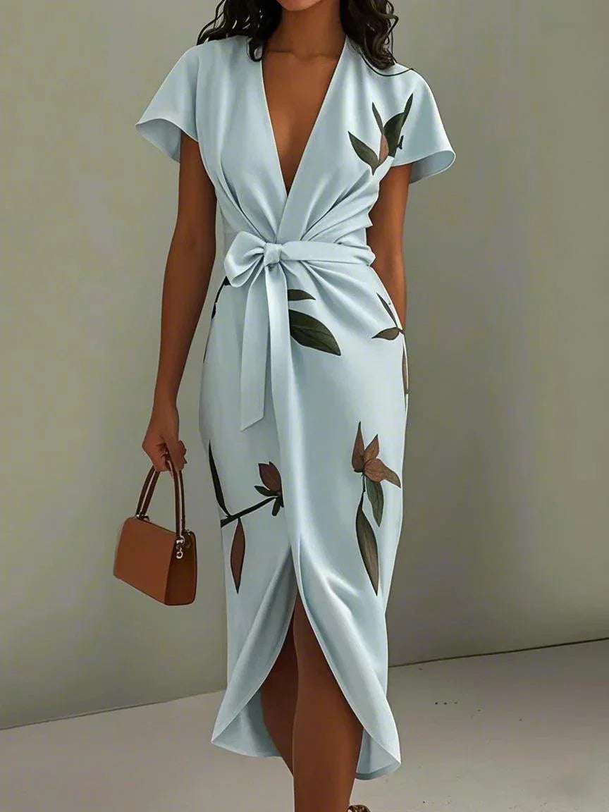 Stylish wrap dress with delicate leaf print, tie waist belt, and flowing silhouette for effortless elegance