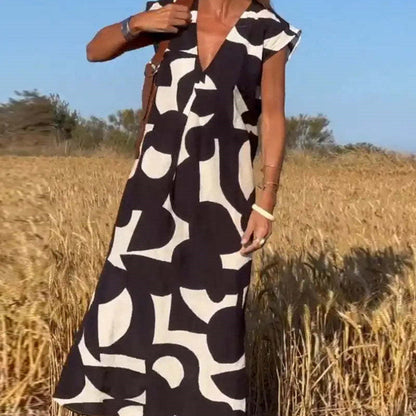 Women's flowy abstract print maxi dress with lace details, bold art-inspired pattern, elegant silhouette